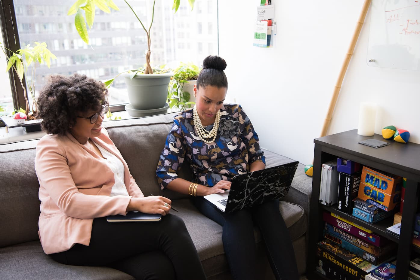 Two women on couch with laptop